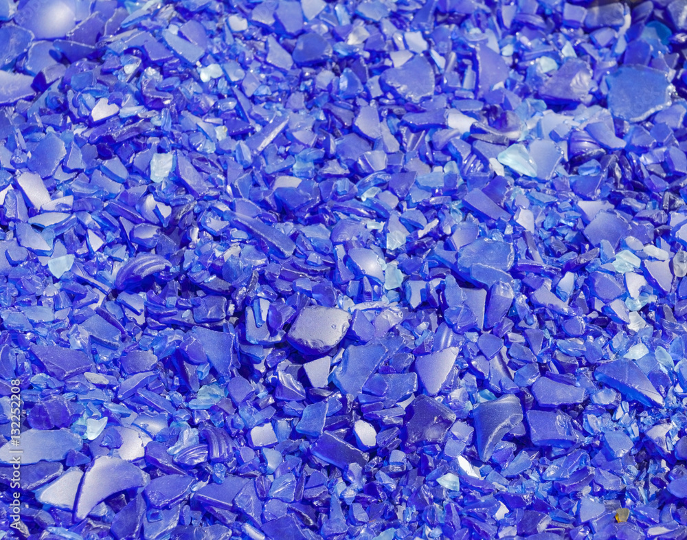 Crushed blue glass peices background. Horizontal. Crushed blue glass peices background. Horizontal.