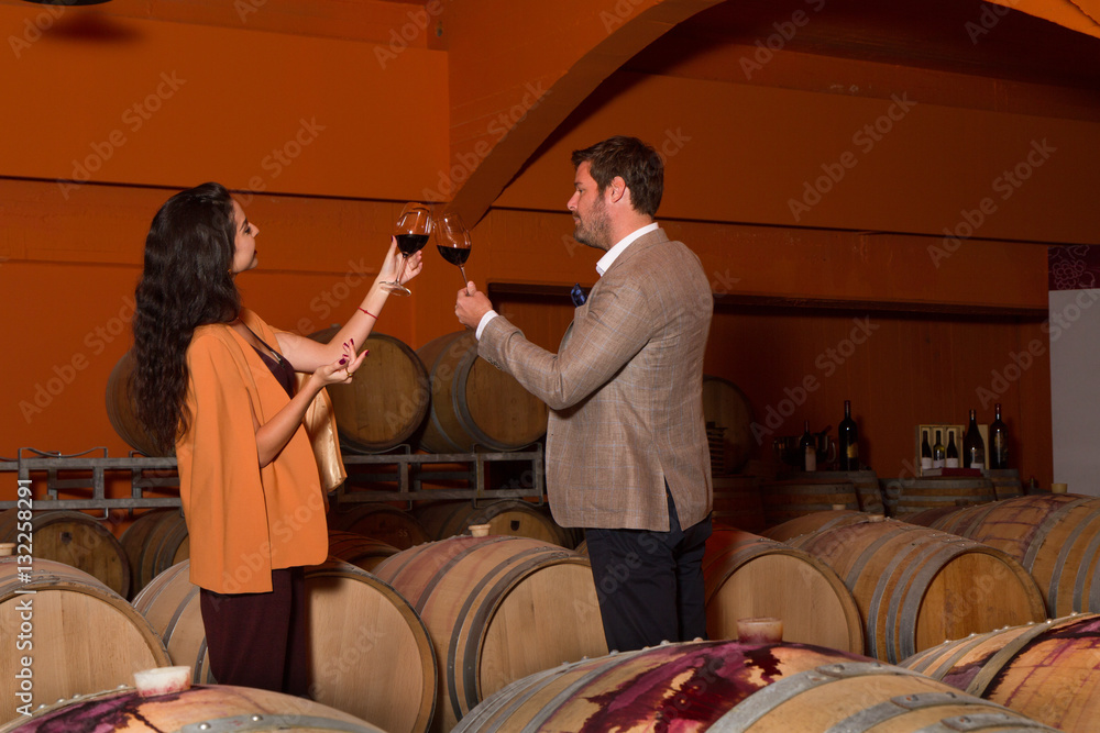 Elegant young couple wine tasting sightseeing tour visiting winery cellar - obrazy, fototapety, plakaty 