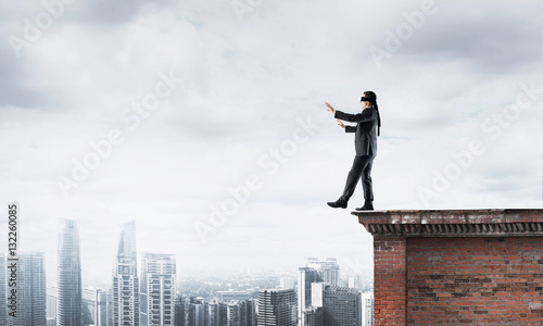 Wallpaper Mural Danger and risk concept with businessman making step from edge Torontodigital.ca