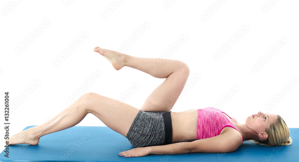 Woman making pilates mat exercises
