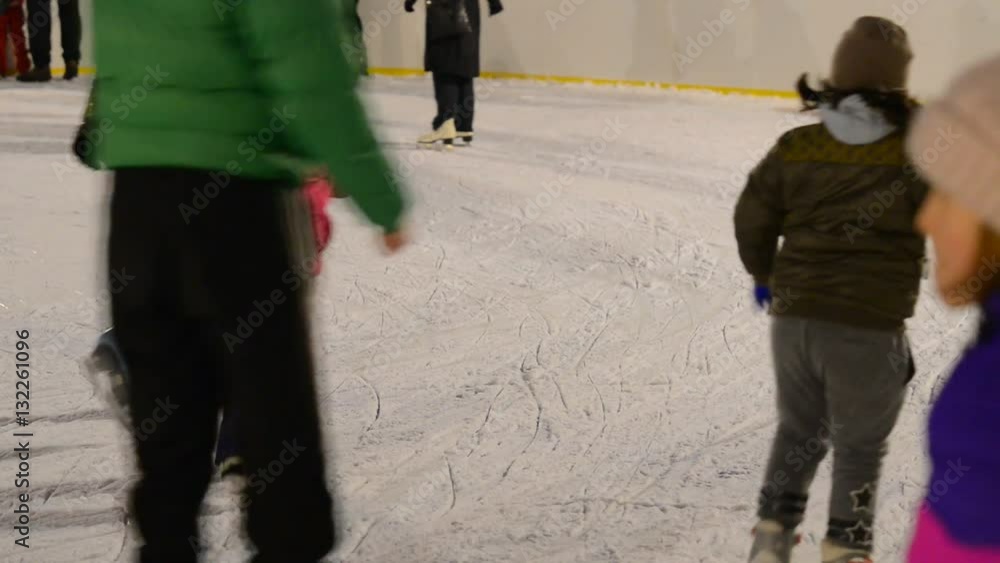 Ice-skaters in the outdoor stadium. real time, no sound,shallow depth of field Ice-skaters in the outdoor stadium. real time, no sound,shallow depth of field