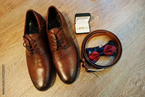 Brown leather men's shoes with belt, bow tie and cufflinks. Set