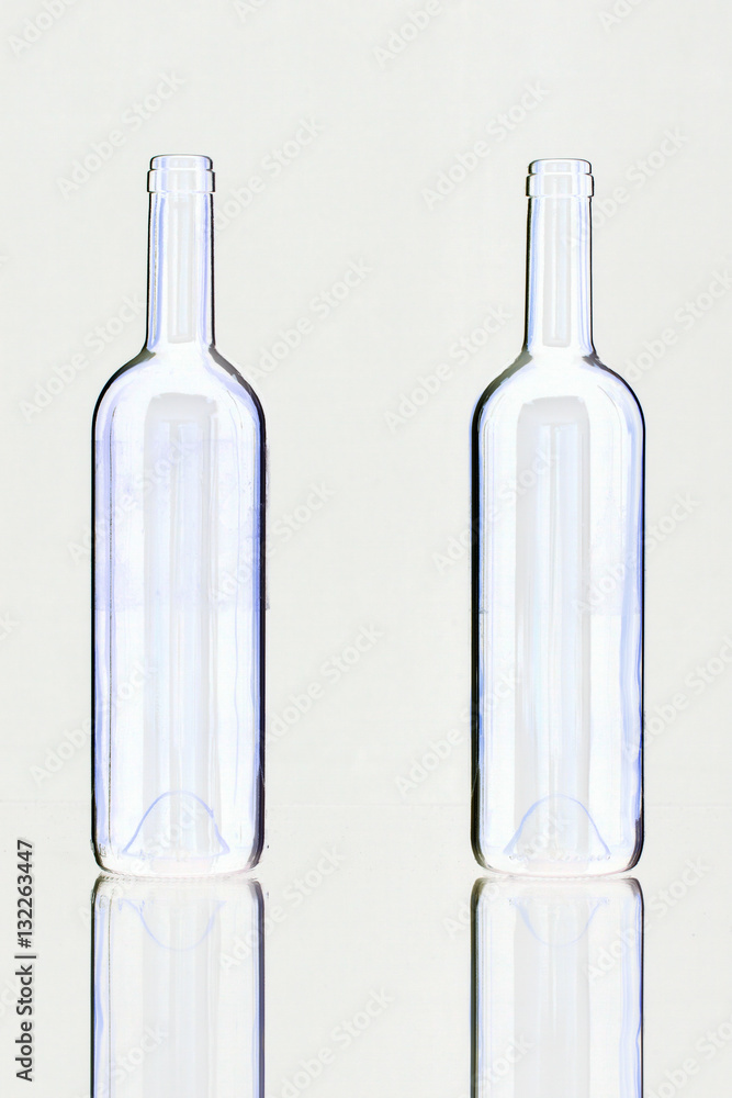 Silhouette of elegant and very old wine bottles on a glass desk Silhouette of elegant and very old wine bottles on a glass desk