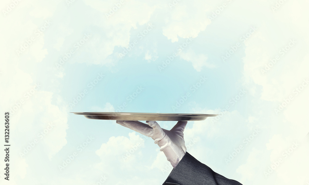 Waiter holding empty silver platter ready for product or item placement