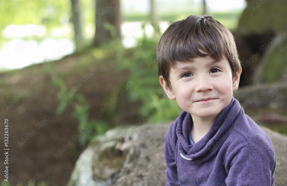 happy kid smiling in the forest