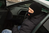 criminal in a mask hijacks the car. car theft