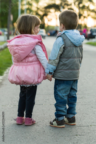 Little boy and girl walking together and holding hands © dobok