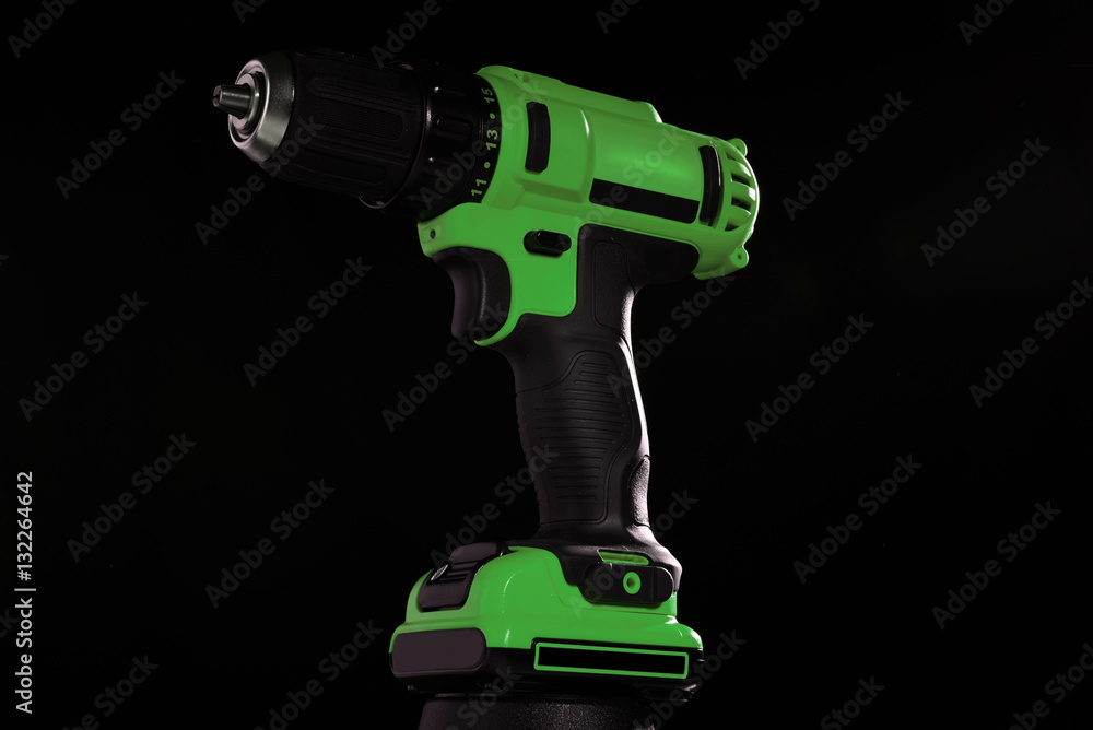 electric screwdriver on a dark background in the studio for adve electric screwdriver on a dark background in the studio for adve