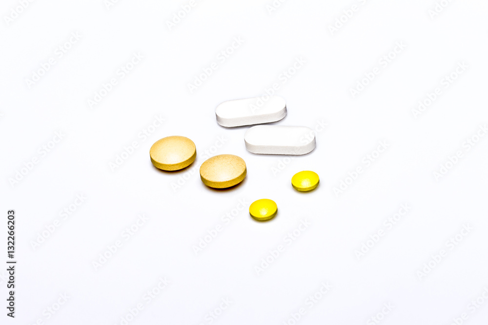 yellow and white pills isolated on white yellow and white pills isolated on white