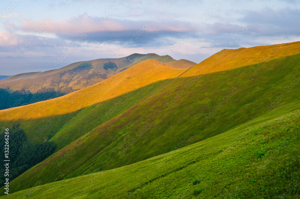 Mountains lit by the sun at dawn. Summer mountain landscape. Eur