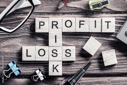 Profit loss and risk words on workplace collected of wooden cube © adam121