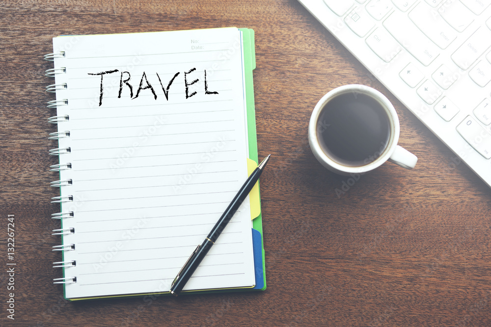 Word travel on notepad and keboard with coffee Word travel on notepad and keboard with coffee