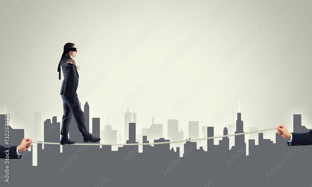 Business concept of risk support and assistance with man balancing on rope