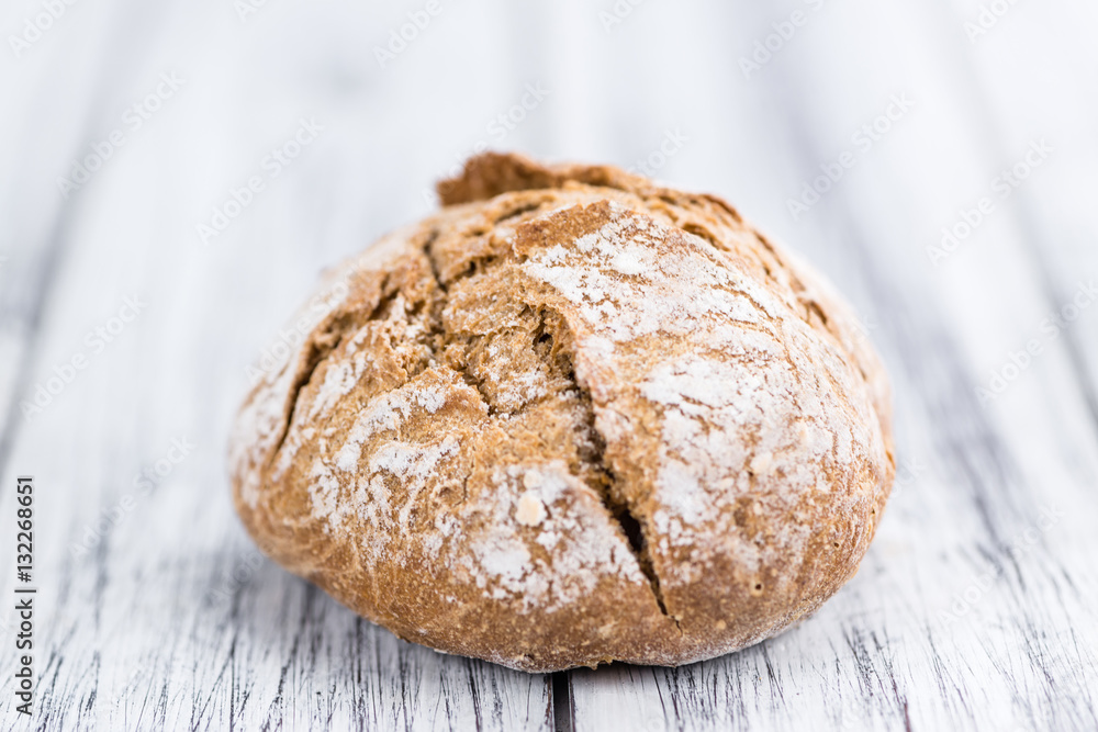 Wholemeal Roll (selective focus) on vintage wooden background