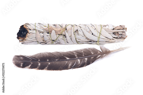 фотографія Sage smudge stick with grade A barred turkey smudging feather isolated on white