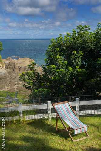 Chaise lounge on the green lawn. Excellent View of the Bay of Combe Martin. North Devon. UK photo