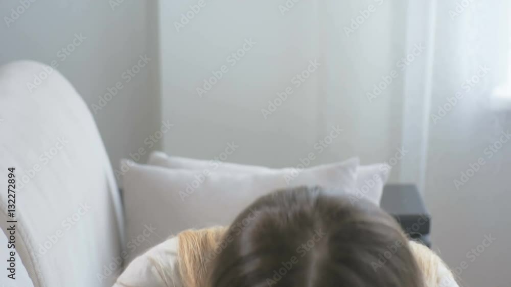Young brunette woman feeling caught flu sitting on sofa and sneezing in paper tissue. Footage shot in 4K Young brunette woman feeling caught flu sitting on sofa and sneezing in paper tissue. Footage shot in 4K