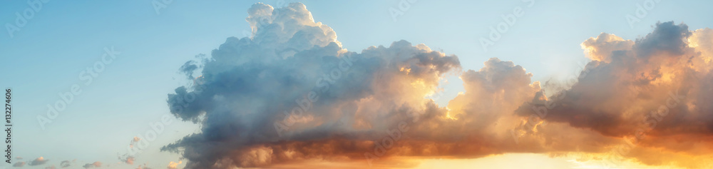 Pastel color heavenly cloud panorama at sunset against light blue gradient