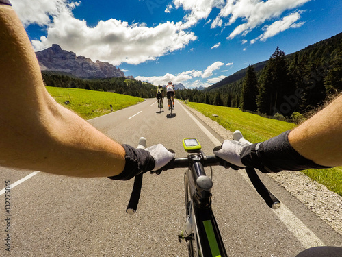 Group of cyclist on mountaionous road. Original point of View POV, view in first person. Focus on hands of cyclist.