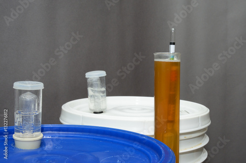 Billede på lærred Home brew beer hydrometer with two primary fermentation buckets
