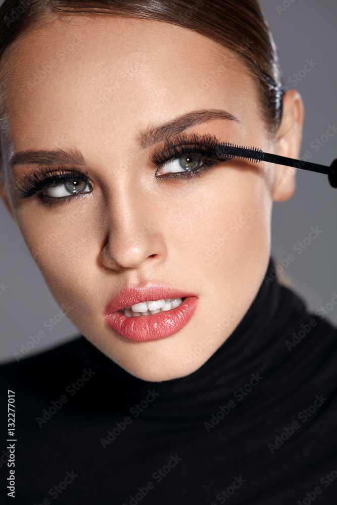 Beauty. Beautiful Woman Applying Black Mascara On Eyelashes