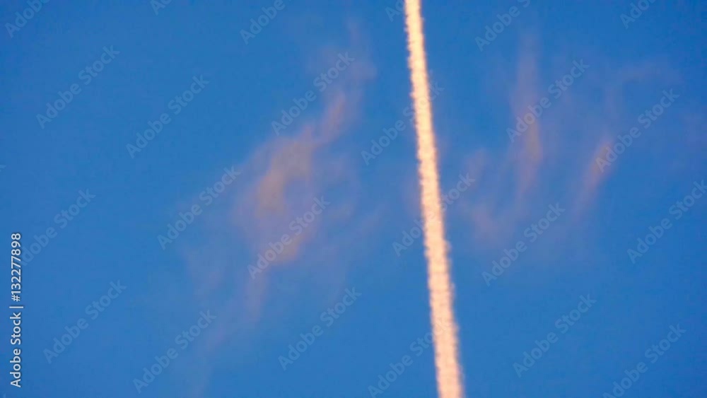 Airplane vapour trails across clear blue sky Airplane vapour trails across clear blue sky