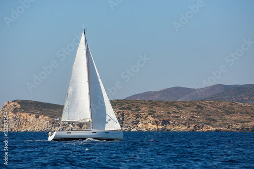 Sailing ship luxury yacht boat with white sails in the Mediterranean Sea.