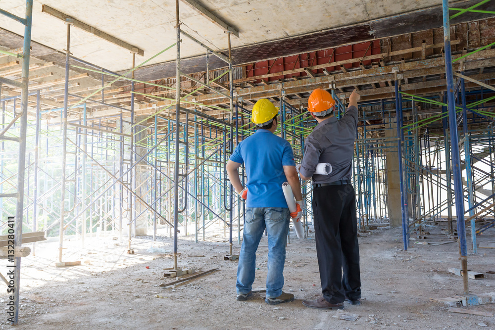 Construction concepts, Engineer and Architect working at Construction Site with blueprint Construction concepts, Engineer and Architect working at Construction Site with blueprint