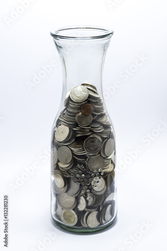 Many bath coin in the bottle on white background.