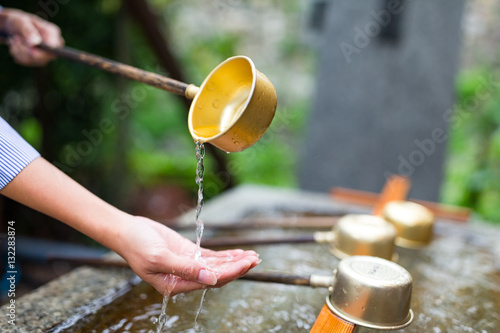 Woman washing hand in water fountain