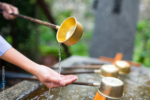 Fotografi Woman washing hand in water fountain