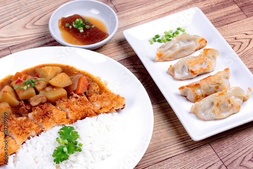  Rice with fried dolly fish topped yellow curry and Gyoza .