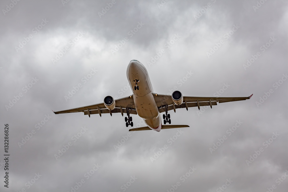 Passenger jet airplane low in the sky preparing to land Passenger jet airplane low in the sky preparing to land