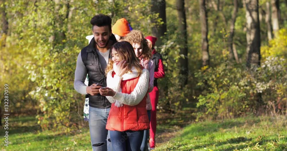 Young People Group Using Smart Phone Internet Laughing Walk Outdoors In Autumn Park, Mix Race Friends Slow Motion 60 Young People Group Using Smart Phone Internet Laughing Walk Outdoors In Autumn Park, Mix Race Friends Slow Motion 60