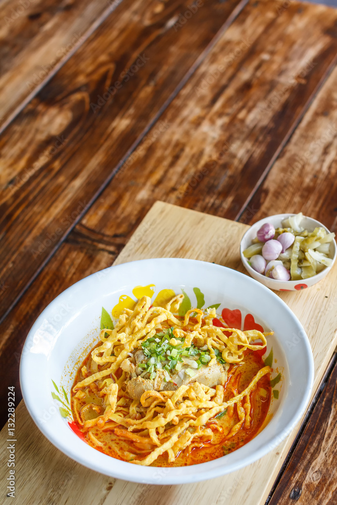 Curried noodle soup (Khao soi) with chicken meat and spicy coconut milk. Thai food. Curried noodle soup (Khao soi) with chicken meat and spicy coconut milk. Thai food.