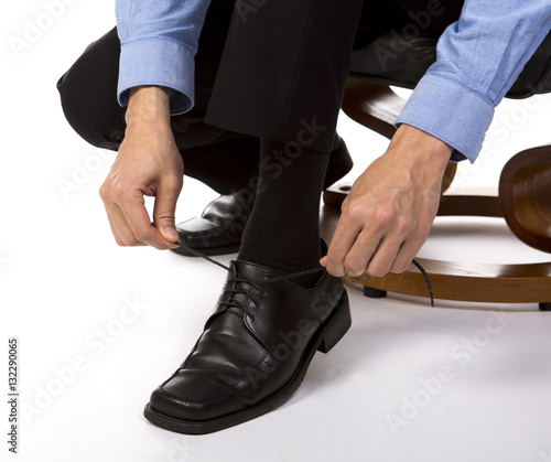 businessman adjusting shoelace