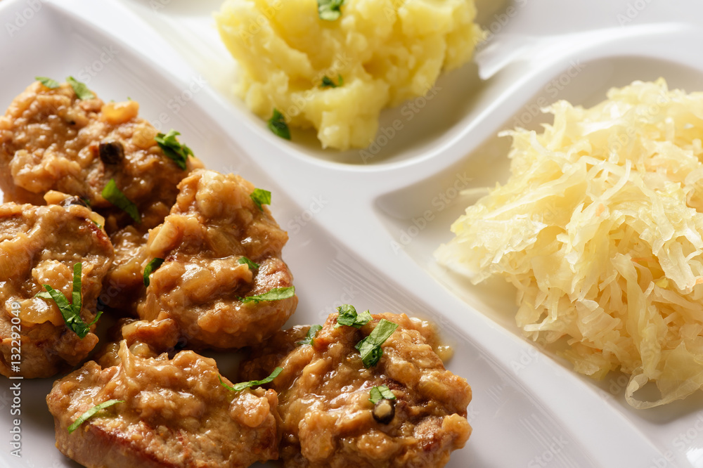 Pork tenderloin cooked in onion sauce served with mashed potatoes. Pork tenderloin cooked in onion sauce served with mashed potatoes.