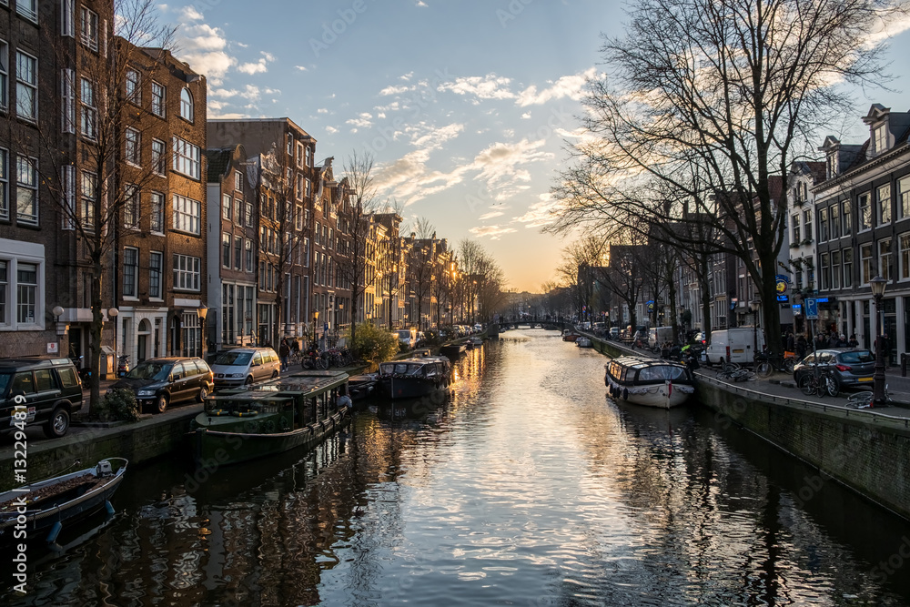 Beautiful sunset over Amsterdam, The Netherlands, with water canals and crazy architecture