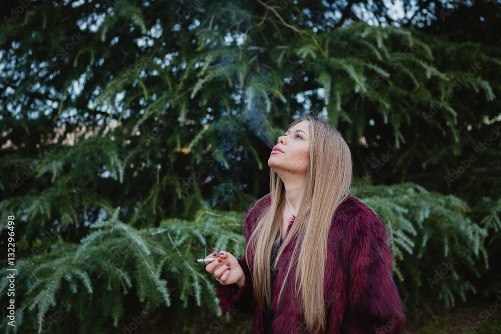 Pretty girl smoking in the park Pretty girl smoking in the park
