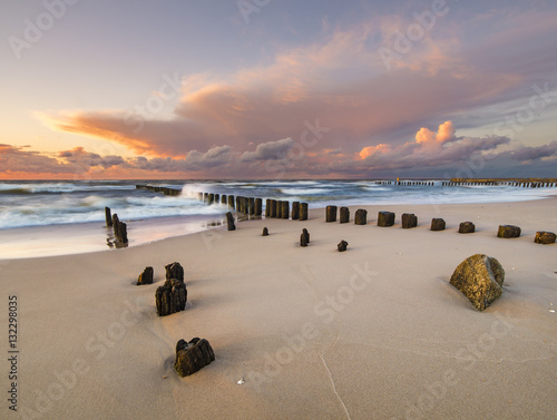beach and offshore breakwaters during a beautiful sunset, baltic sea 