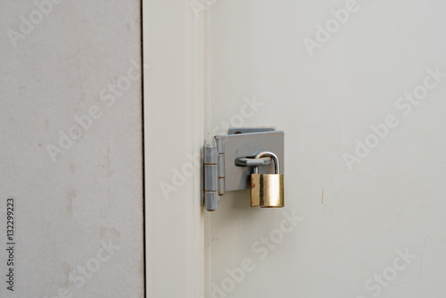 Gold padlock at the white door