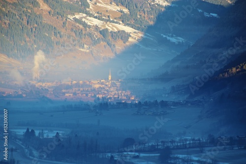 Panoramic view of the village Bad Hofgastein in winter, in mystical, golden morning light. Austria, Salzburger Land, Europe. photo