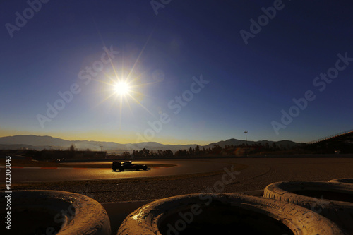 Canvas Print Formula One car on track at sunset