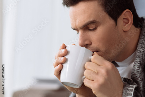 Handsome brunette man enjoying his tea