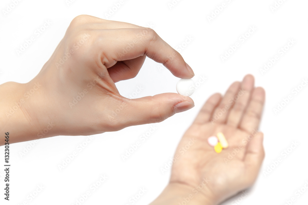 Pick one pill from the medicines in the hand on white background isolated