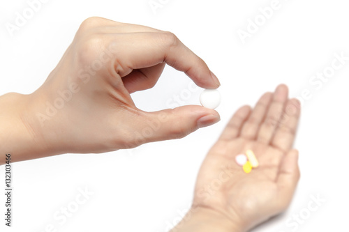 Obraz na płótnie Pick one pill from the medicines in the hand on white background isolated w salonie