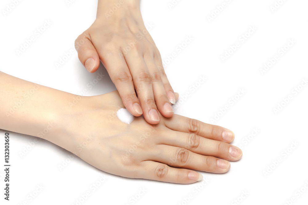Apply small amount of body lotion to moisture the hand skin on white background isolated