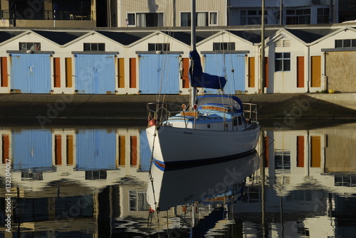 Sailing boat and boat houses at Welllington New Zealand photo