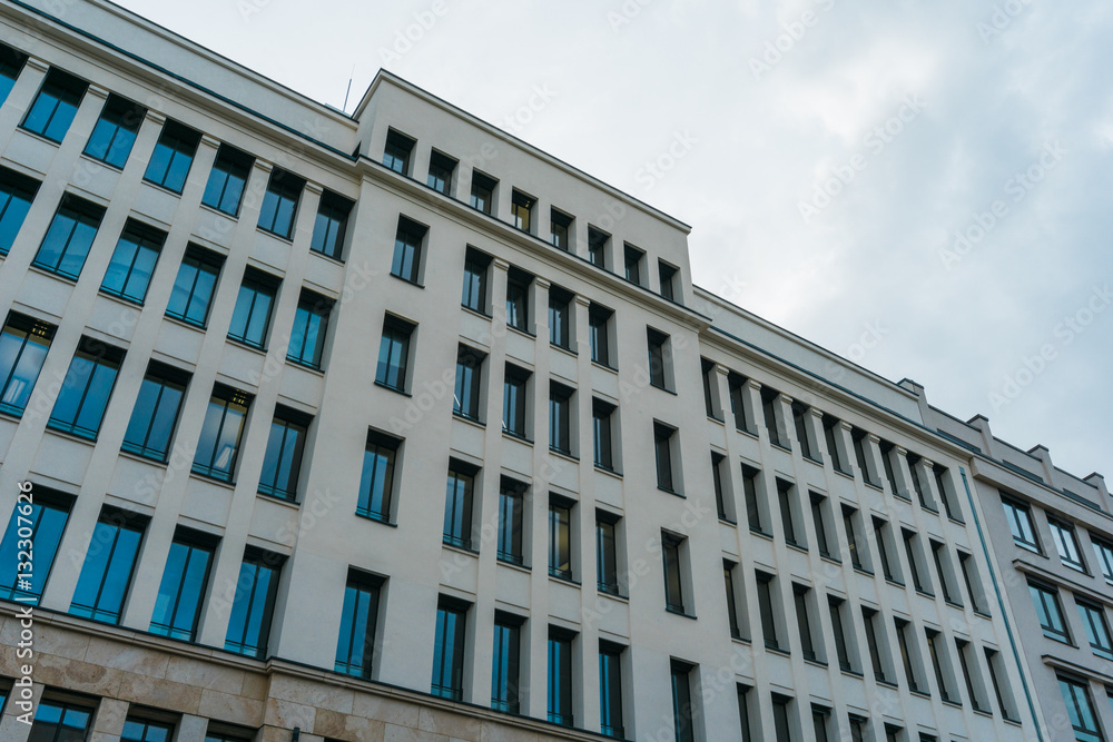 white facaded and big building with small windows white facaded and big building with small windows