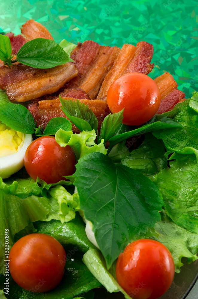 Plate with cherry tomatoes, herbs, olive oil, eggs and bacon Plate with cherry tomatoes, herbs, olive oil, eggs and bacon